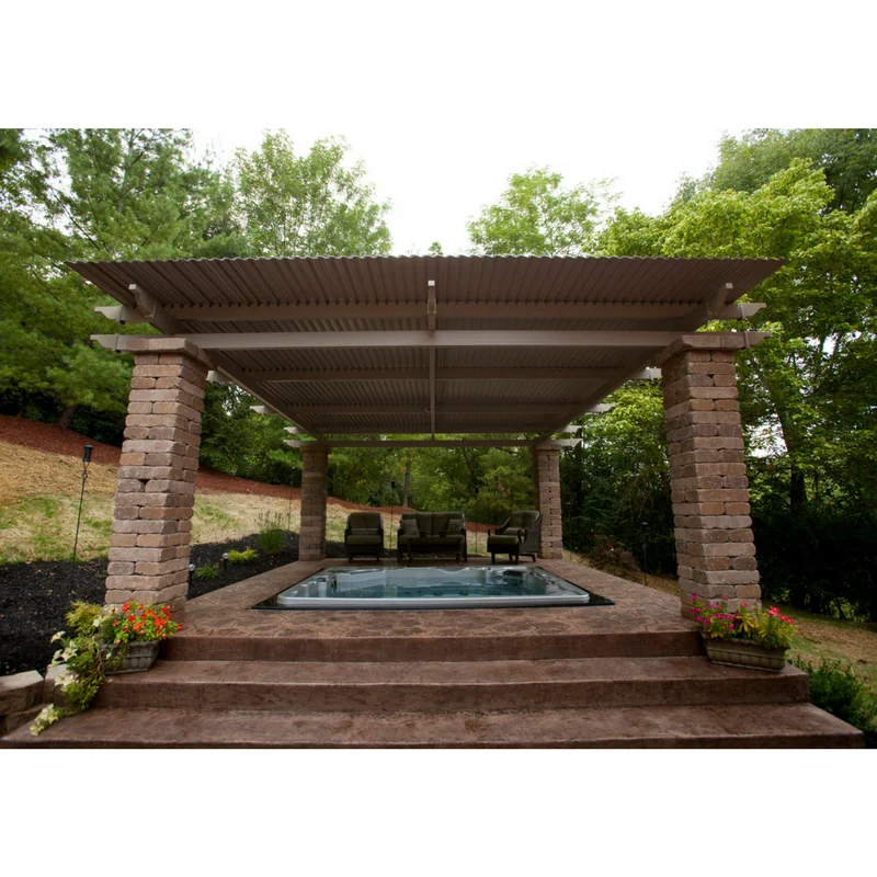 Hot tub and outdoor living space covered by a custom roof structure.