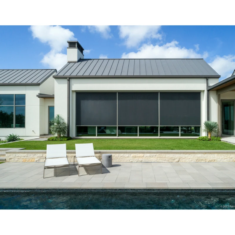 Exterior of a luxury home with custom, motorized exterior shades.