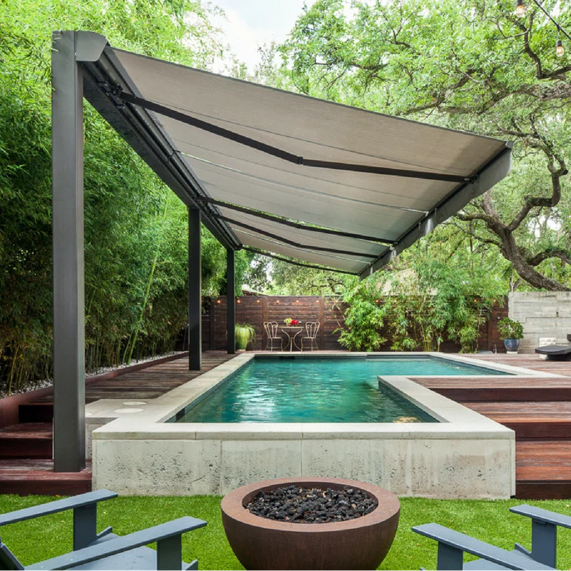 Retractable awning structure providing shade for an outdoor pool area.