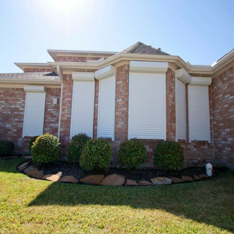 White exterior shutters installed on six windows of an Austin area home.