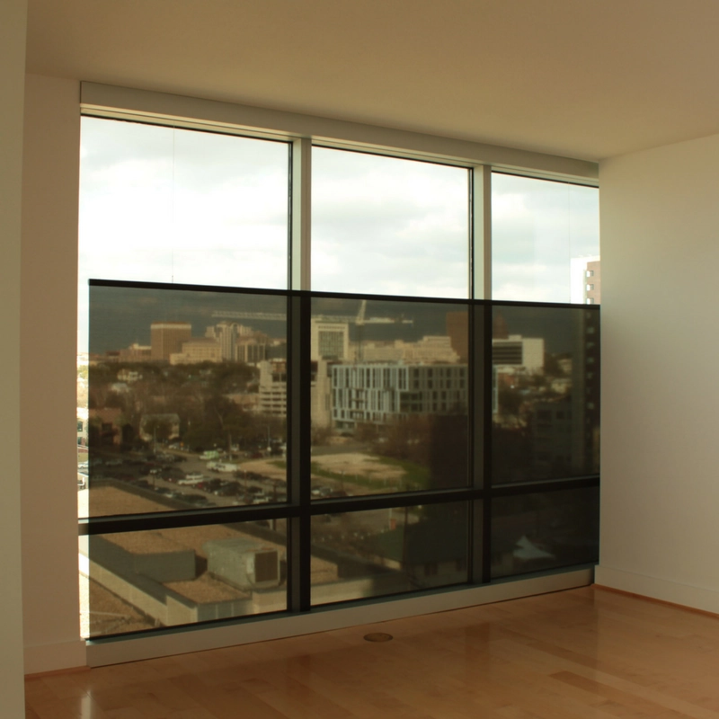 Half-raised bottom-up screens, providing privacy and shade to an apartment.