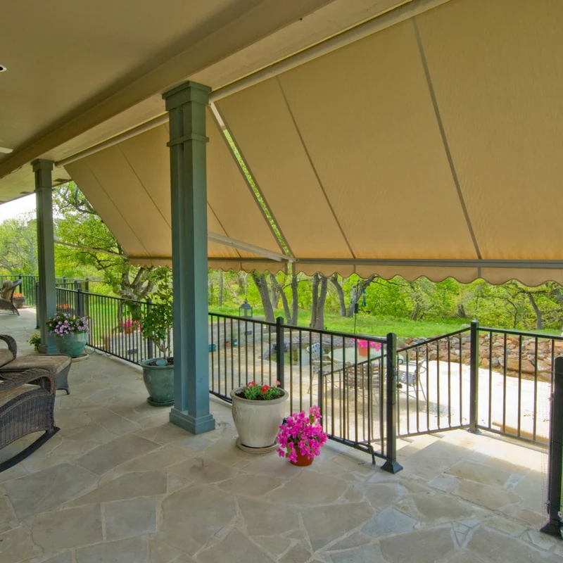 Classic exterior awning providing shade and cooling an Austin home's back patio.