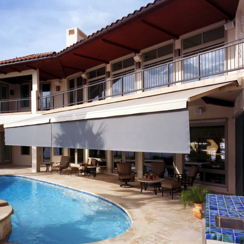 Luxurious backyard with half-lowered, custom-built exterior awning.