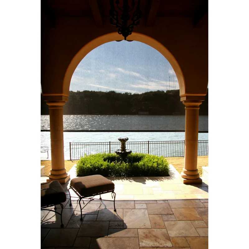 Semi-darkening outdoor privacy screen on a Lake Travis home, half-lowered.