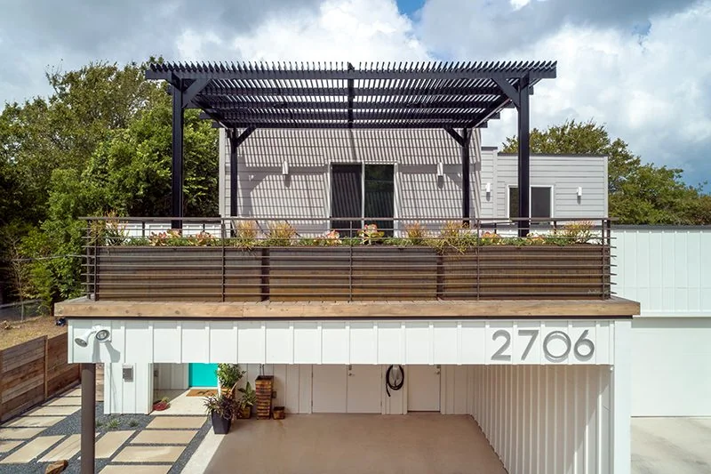 Custom built and installed roof structure over a rooftop patio area on a modern home.