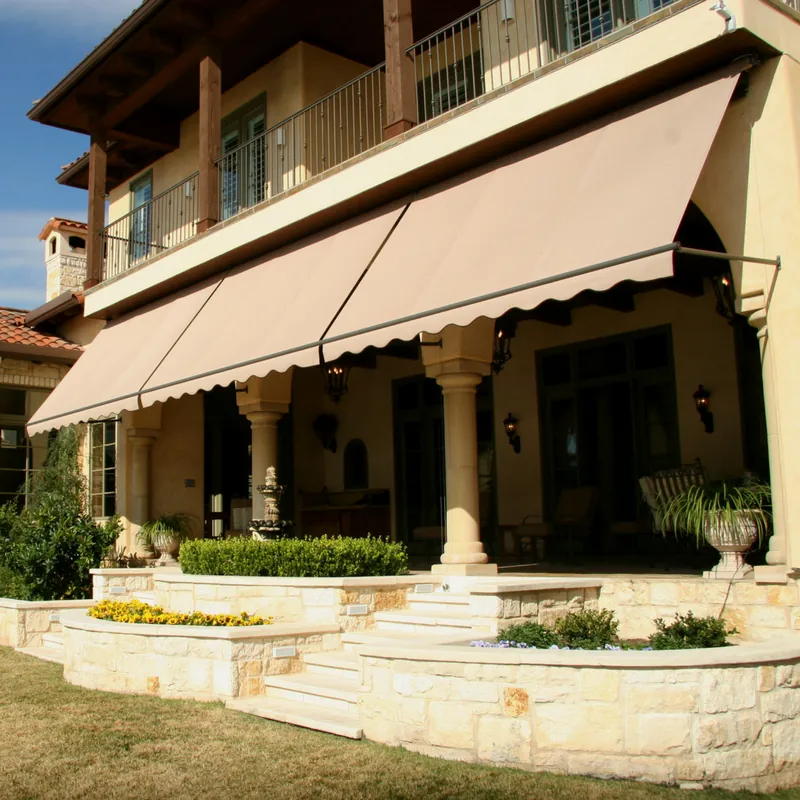 Retractable patio awning lowered over the front porch of an Austin home.